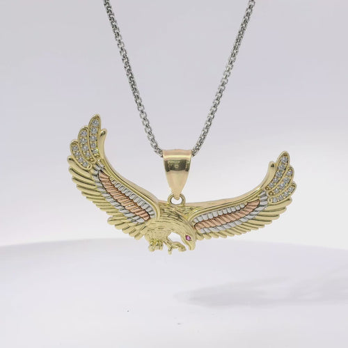 14KT Gold Charm Large Tri Tone Soring Eagle with Red CZ Eye, White CZ Stones Wing Tips, and Plain Bell
