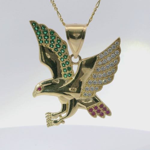 14KT Gold Charm Small Left Facing Soaring Eagle with Round White, Red, and Green CZ Stones Wings, Red CZ Stones Eye and Plain Bell