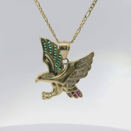 14KT Gold Charm Small Left Facing Soaring Eagle with Baguettes White, Red, and Green CZ Stones Wings, Red CZ Stones Eye and Plain Bell