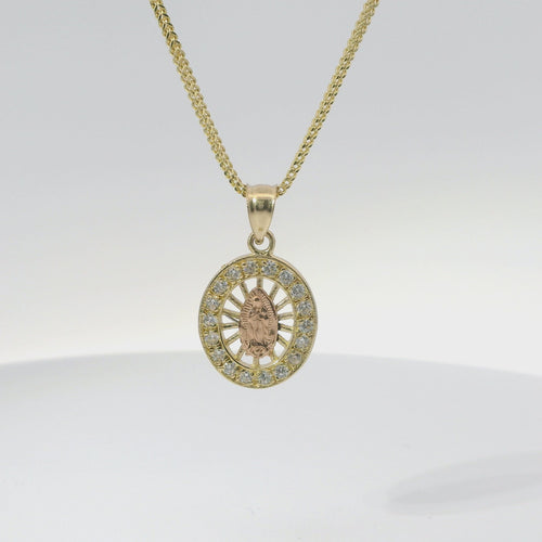 14KT Gold Charm Extra Small Oval Two Tone Virgin Mary Open Stripe Center with White CZ Stones Border and Plain Bell