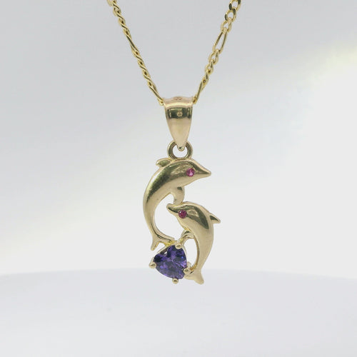 14KT Gold Charm Two Small Dolphins with Plain Bodies, Dark Pink CZ Stones Eyes, Purple CZ Stone Heart Base, and Plain Bell