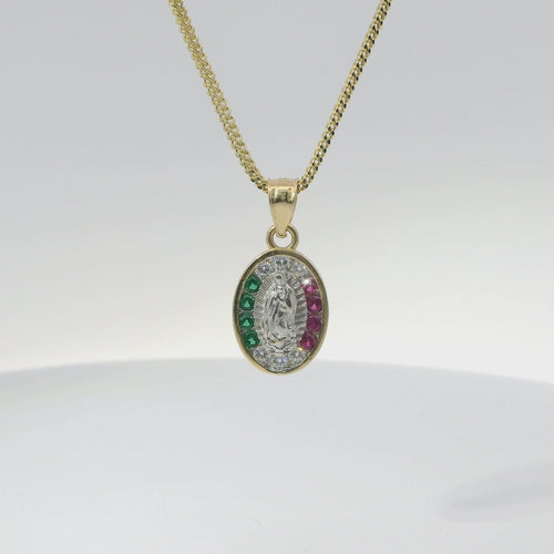 14KT Gold Charm Small Tri Tone Oval Virgin Mary with Red, Green, and White Round CZ Stones Border with Plain Bell